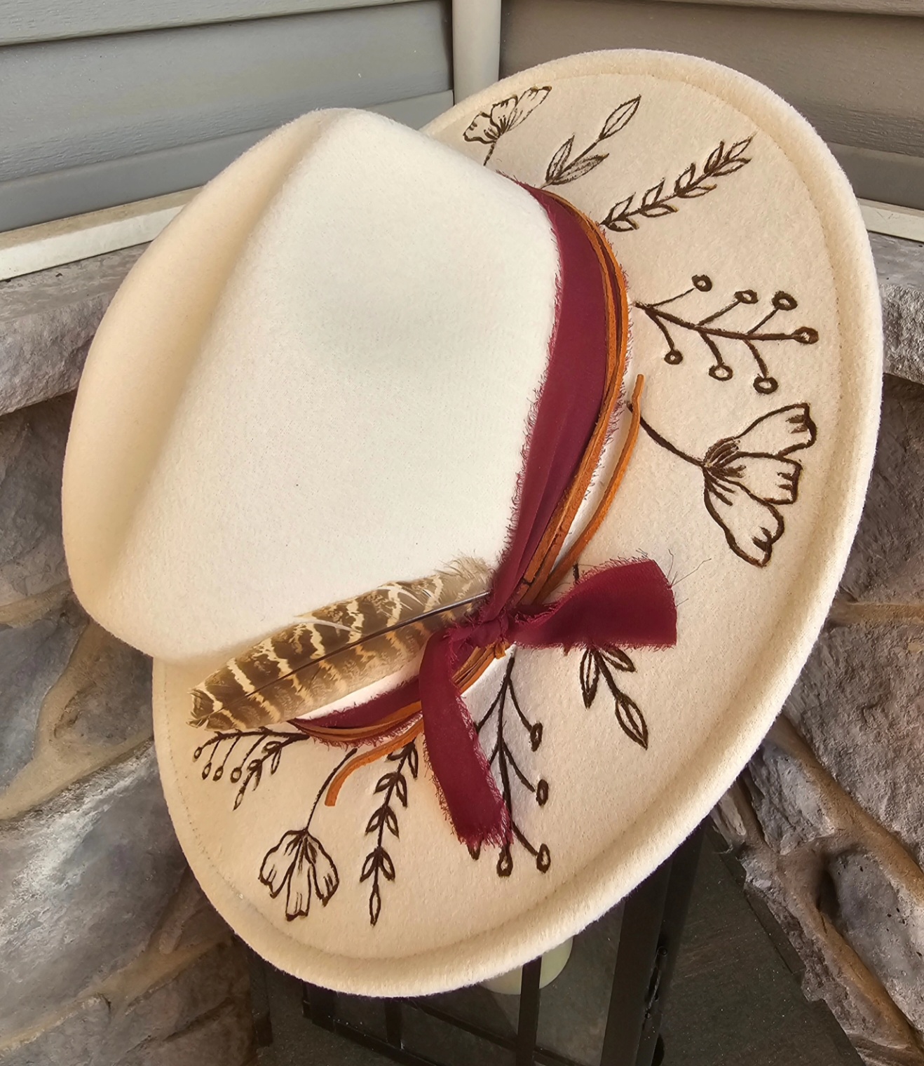 Cream Fedora w/ wild flowers and wine band and feathers $85