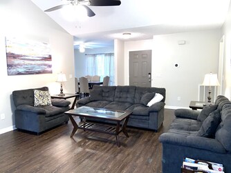 plenty of seating in living room with couch, love sofa, and chair