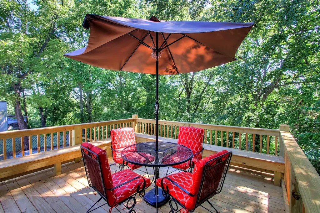 deck secluded in the trees with wrap around bench seating 