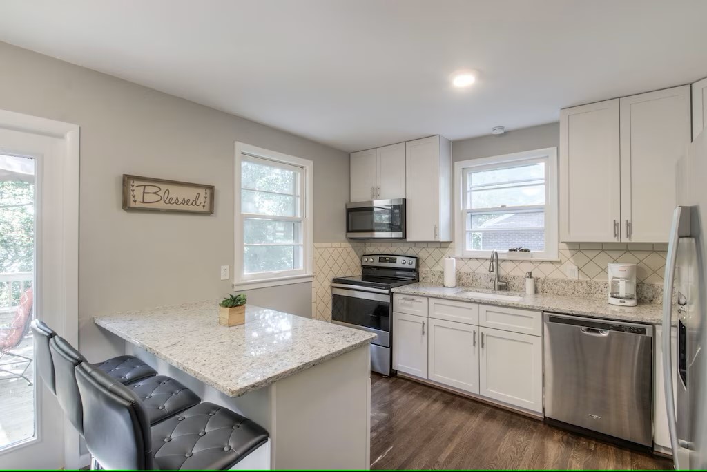 kitchen on main floor next to living room and deck