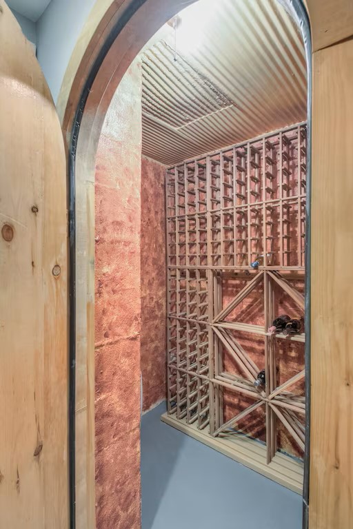 wine cellar next to bar room in basement
