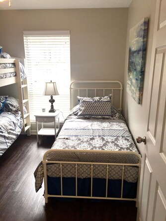 twin bed and bunkbed across from laundry closet and next to queen room