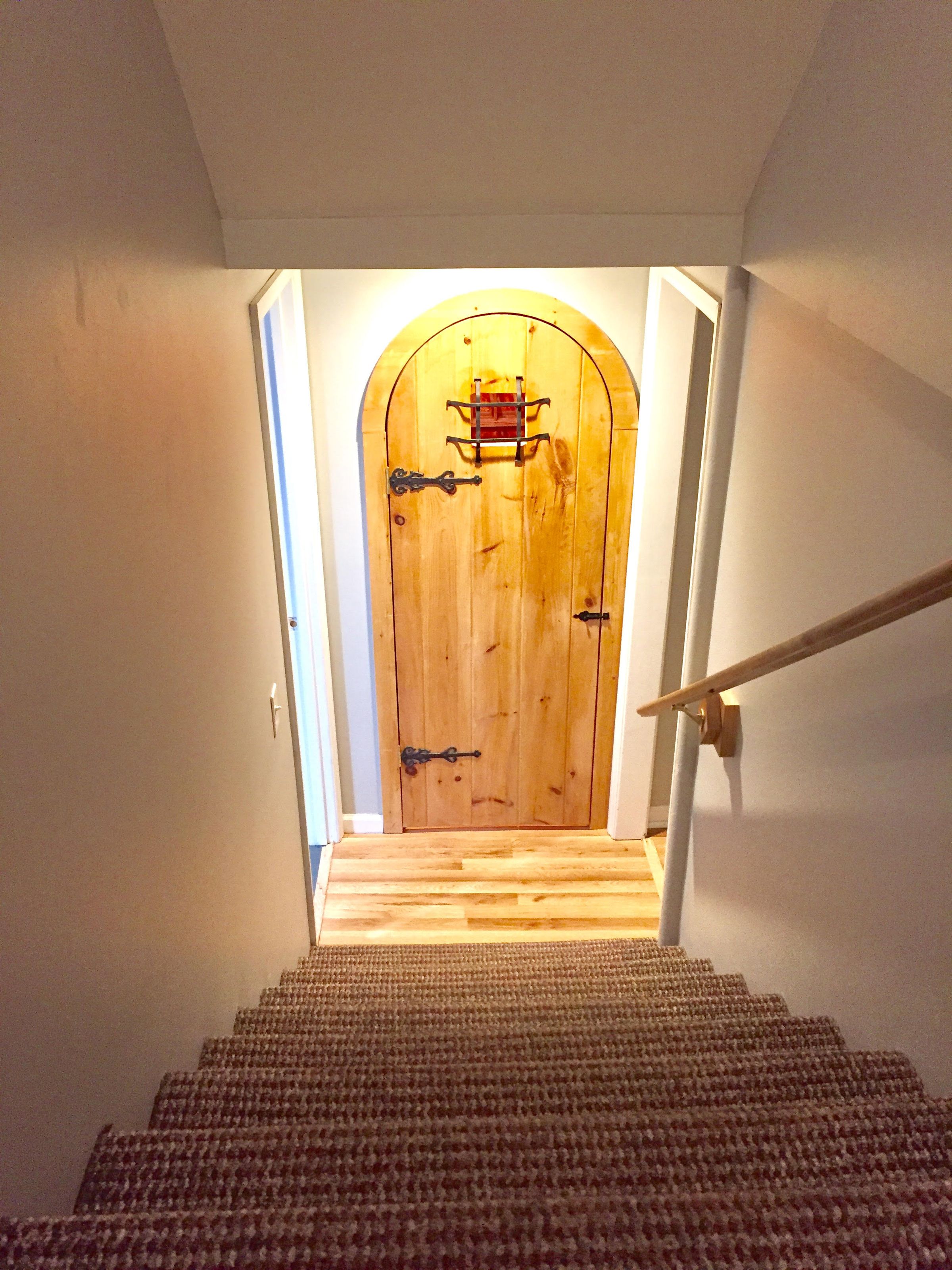 cellar at bottom of basement steps, bar room to right and private retreat room with king to left