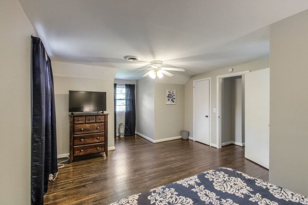 master room with smart tv and walk-in closet