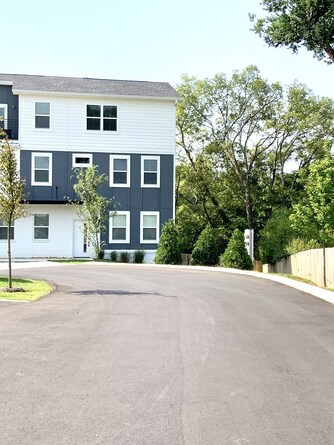 larger corner unit, backyard lawn behind fence to the right