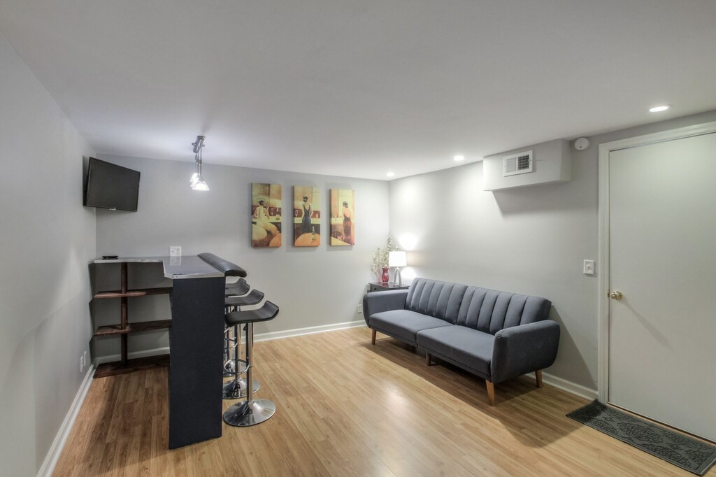 bar room with full futon -bedding in closet, entrance to garage