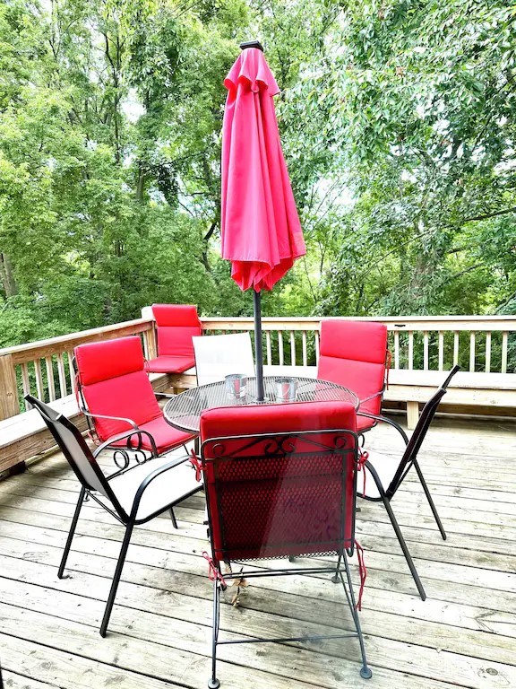 new deck umbrella and additional gray sunchairs