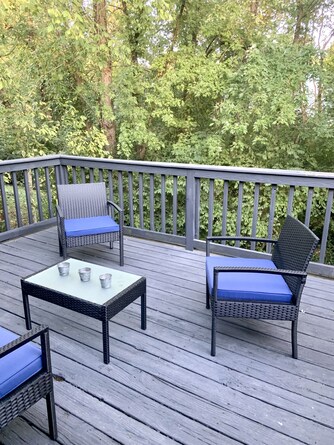 secluded deck with small creek running at end of wooded property