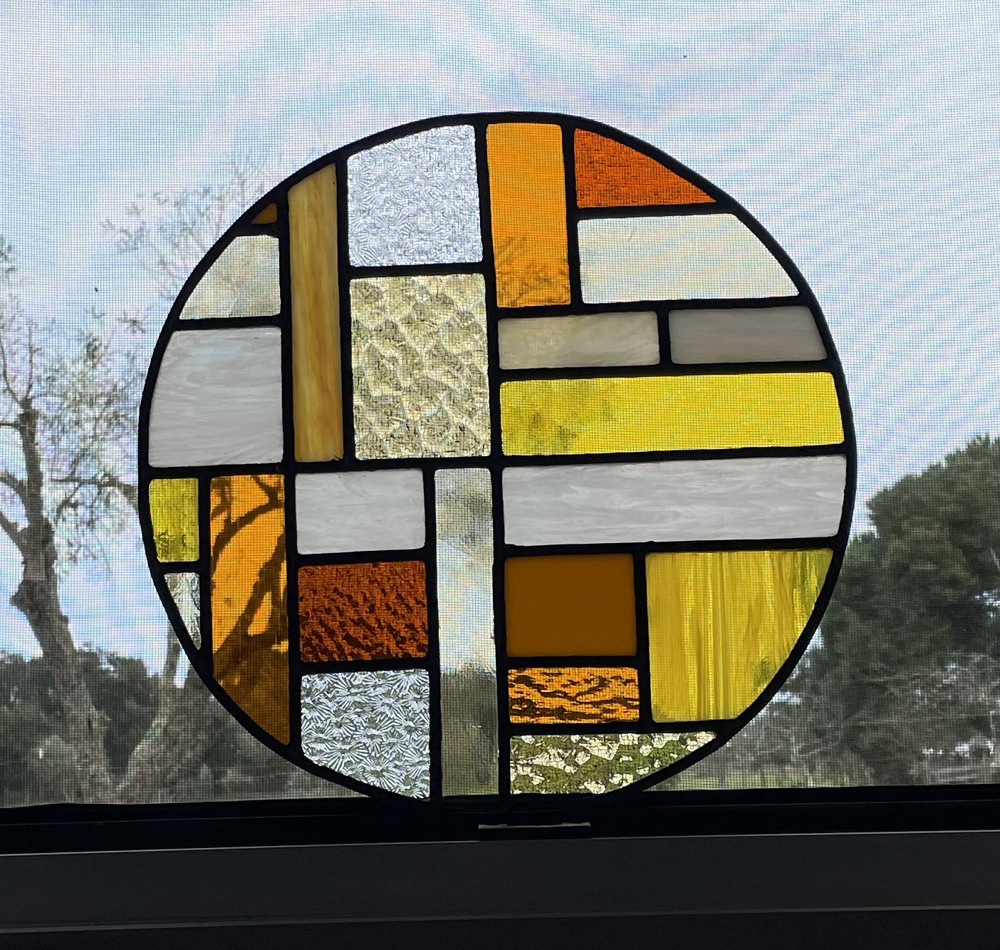 Circular window panel, one of several pieces from a larger set