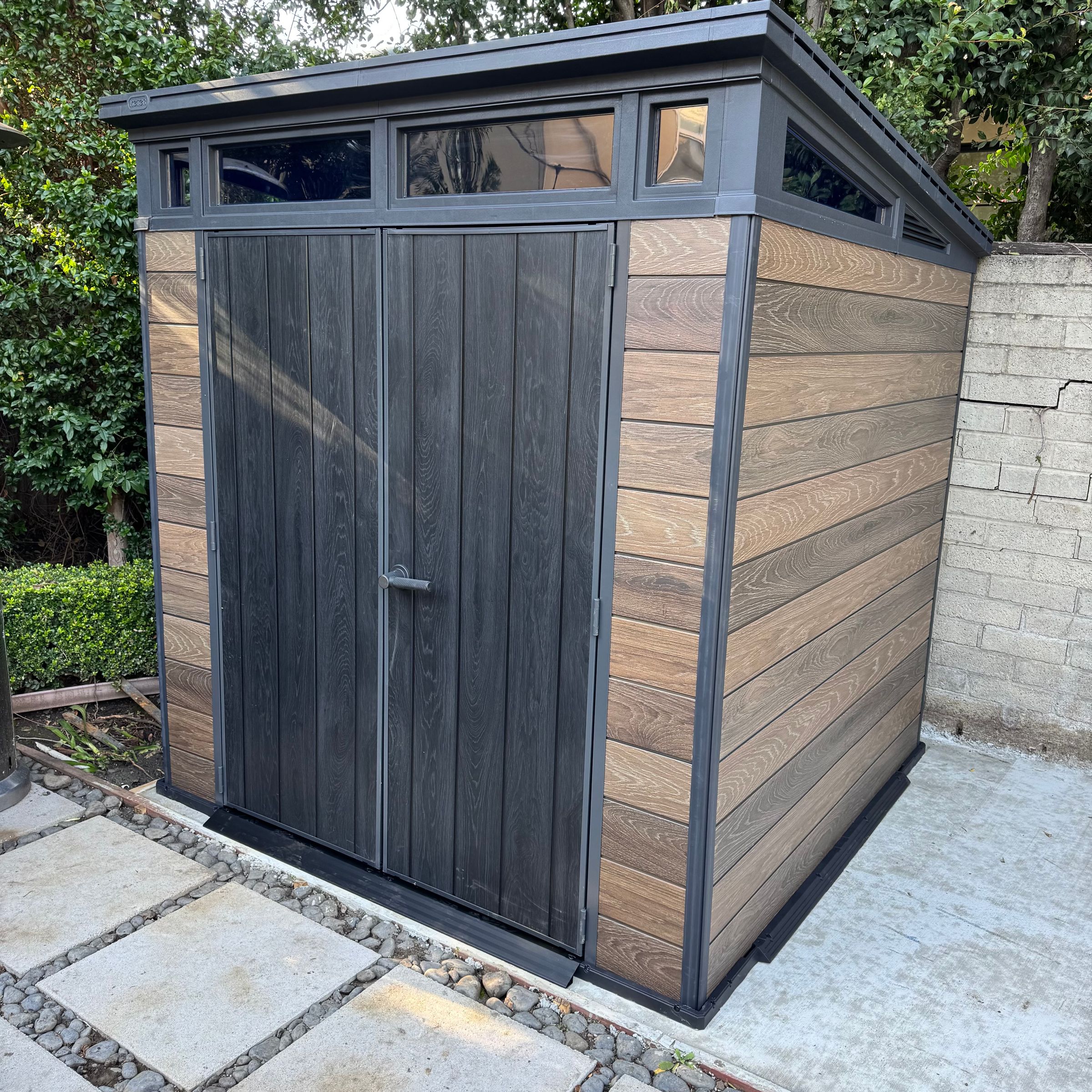 Wood-Style Outdoor Shed Assembly