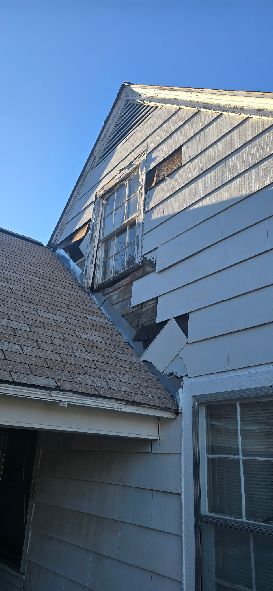 Before: water damage and deteriorated siding