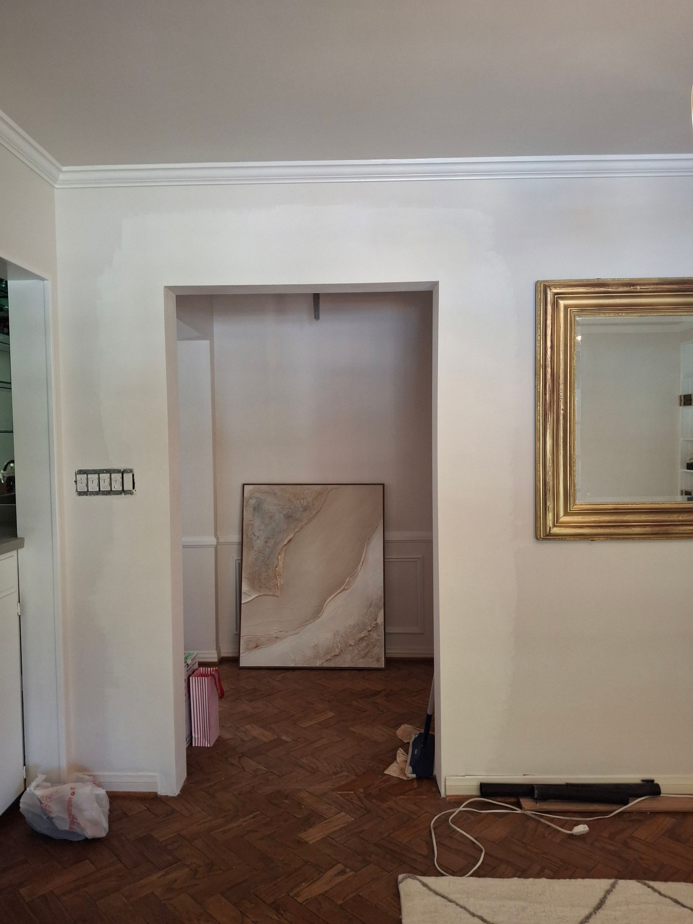 Completed wall restoration – smooth painted surface and doorway finish