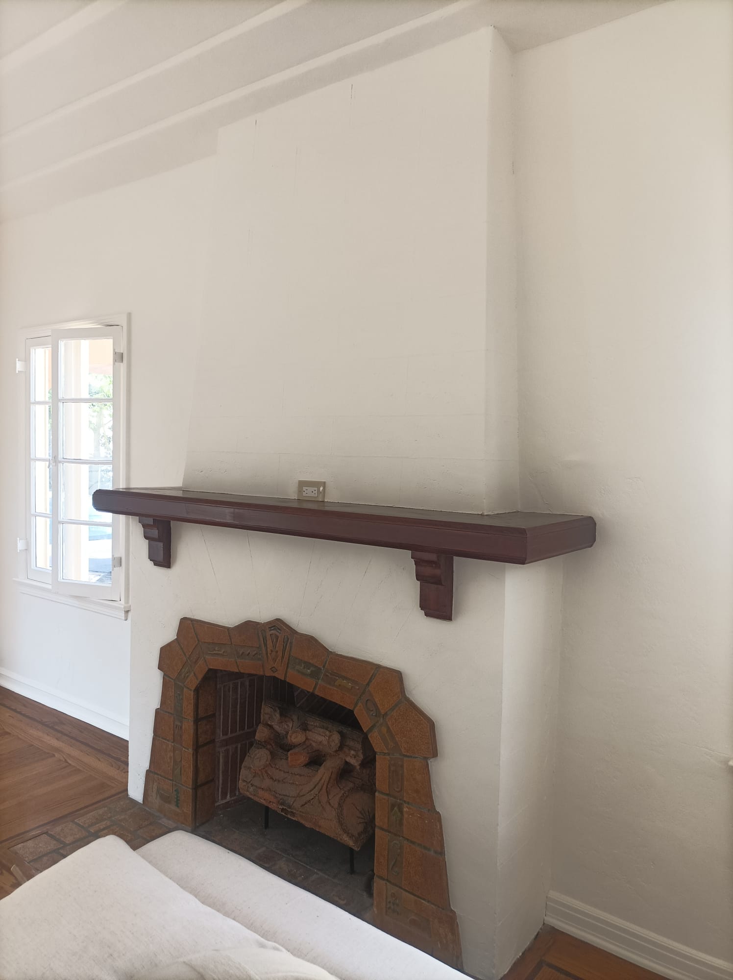 Finished fireplace – restored mantel and fresh white walls, CA