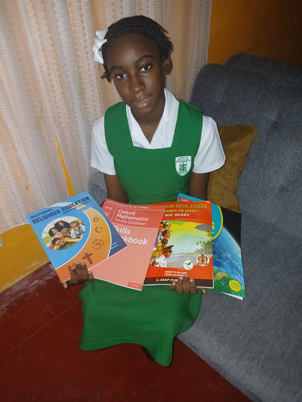 Morant Bay High School Student with her back to school books sponsored by TCBF
