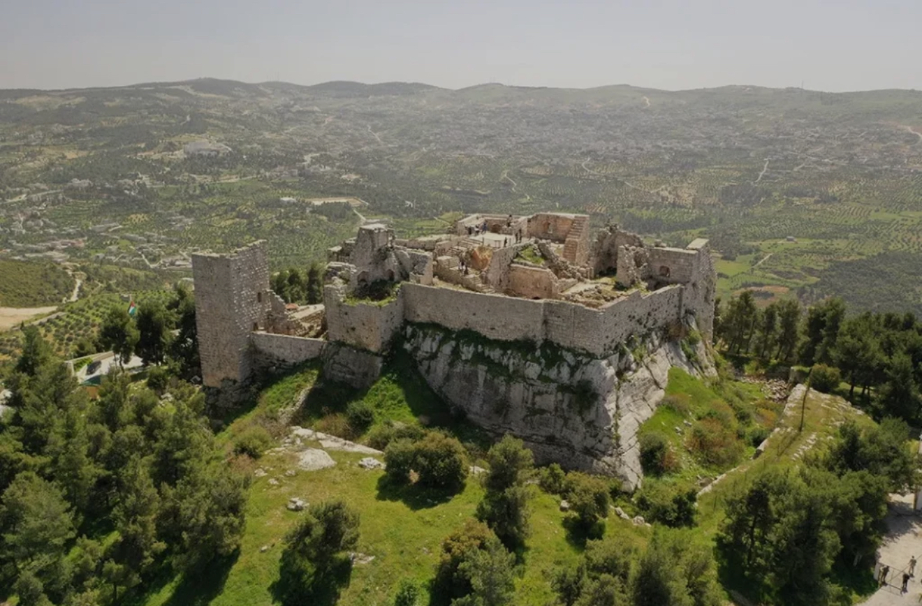 Ajloun is a place where history and nature come together in perfect harmony. Nestled in the lush green hills of northern Jordan, it is home to the famous Ajloun Castle, also known as Qal‘at Ar-Rabad, a 12th-century fortress built by Saladin’s general to defend the region against Crusader invasions. The castle’s towers and walls still stand strong, offering breathtaking panoramic views of the Jordan Valley, the Dead Sea, and even Palestine on a clear day. Surrounding the castle, the Ajloun Forest Reserve showcases a rare side of Jordan — rolling hills covered with pine, oak, and olive trees, making it a haven for hikers, nature lovers Why It’s Special  Ajloun is a unique combination of nature and history — a place where rolling green hills meet medieval Islamic fortresses. It offers a cooler climate, scenic beauty, and a glimpse into Jordan’s defensive past.  ✨ In short: Ajloun is where castles rise above pine-clad hills — a fortress among forests, echoing history and nature’s harmony.