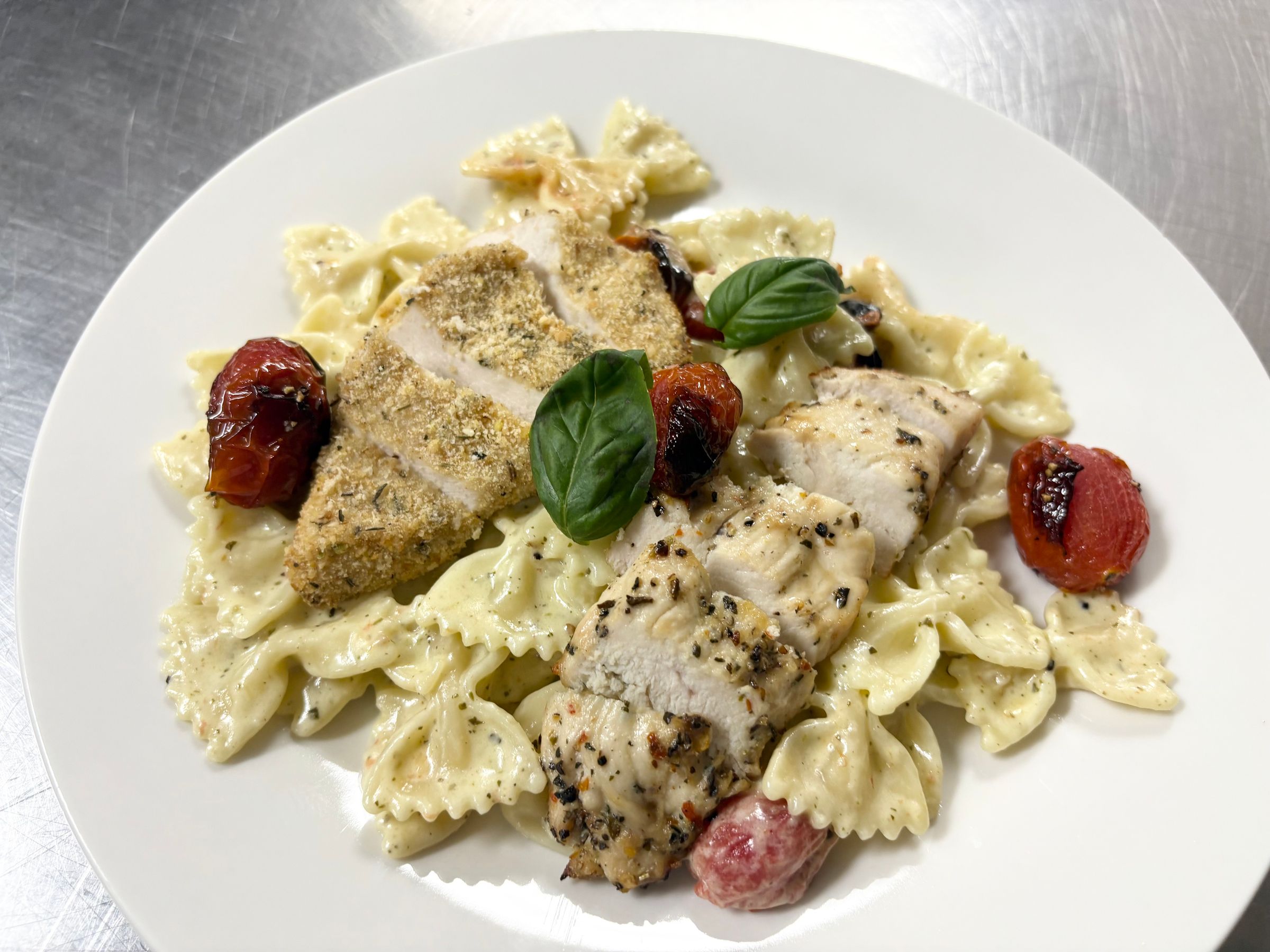 Herb Marinated Chicken, Parmesan Crusted Chicken with House Made Pesto Cream Sauce, Bowtie Pasta