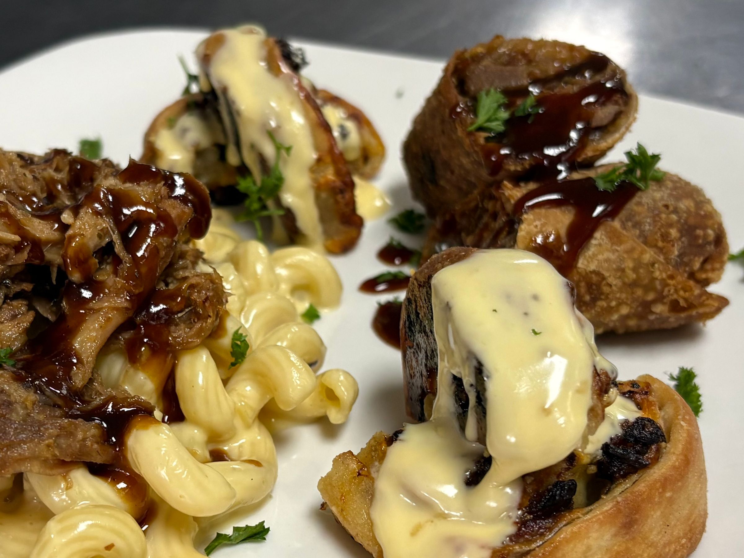 BBQ Three Cheese Mac, Philly Cheesesteak Pinwheel with House made Cheese Sauce, Brisket Egg Rolls
