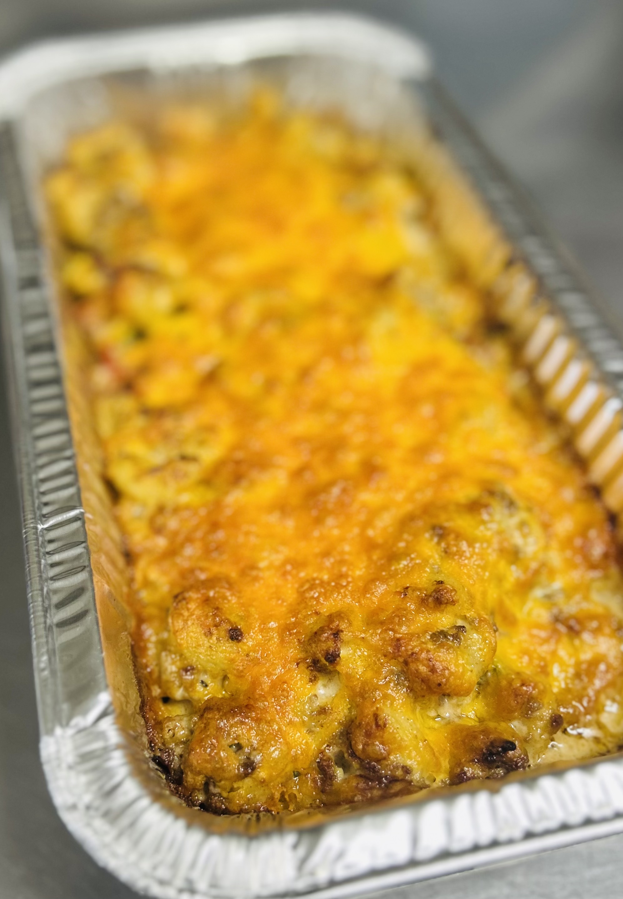 Boot Scootin' Beef Pasta: Cavatoppi loaded with seasoned Ground Beef, Corn, Tomatoes, Green Peppers. Smothered in Creamy Cheese Sauce.
