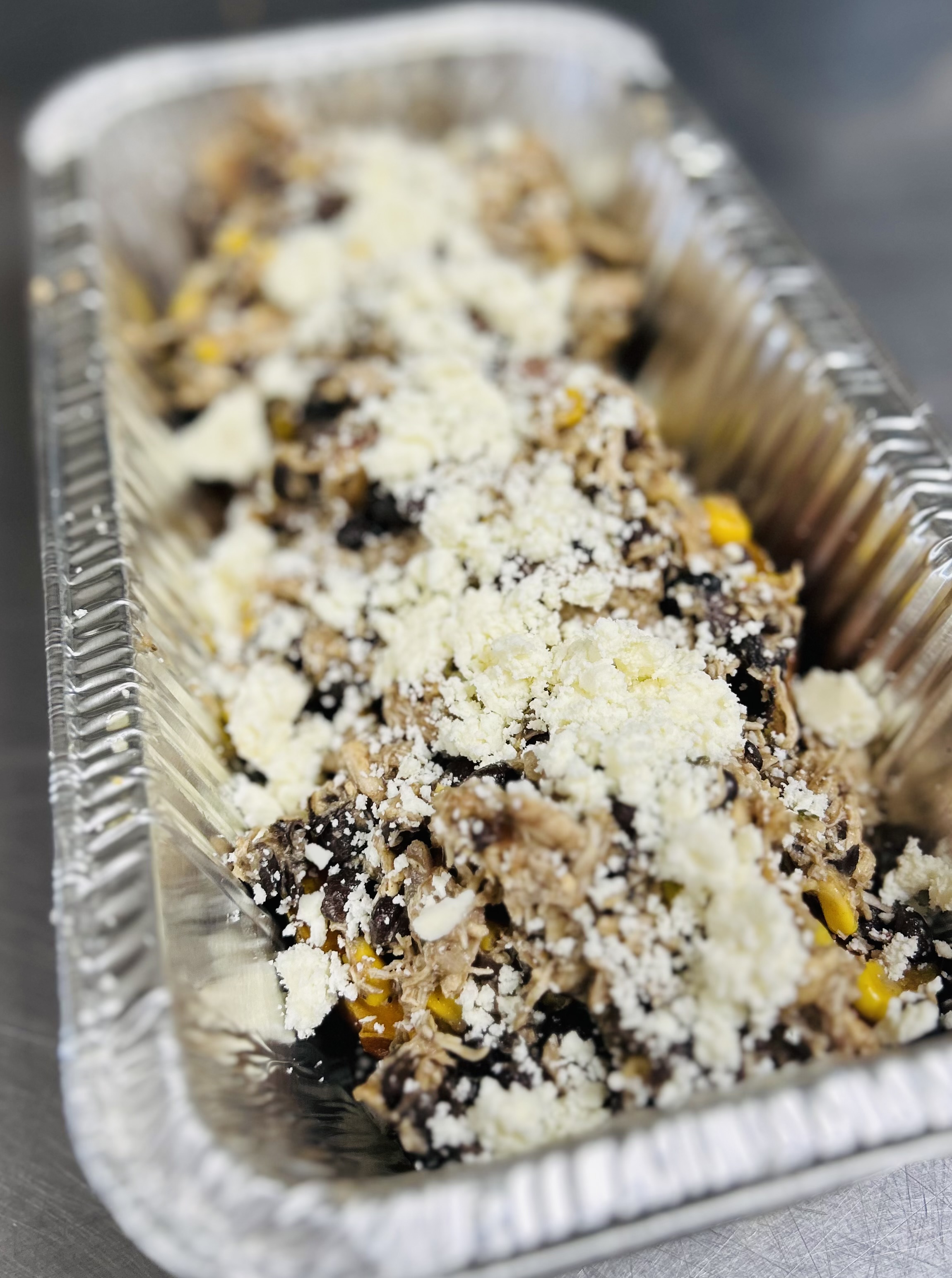 Sweet Southern Stuffers: Jumbo baked Sweet Potatoes stuffed with Smoked BBQ Chicken, Corn and Black Bean Salsa. Side of Cilantro/Queso Fresco.