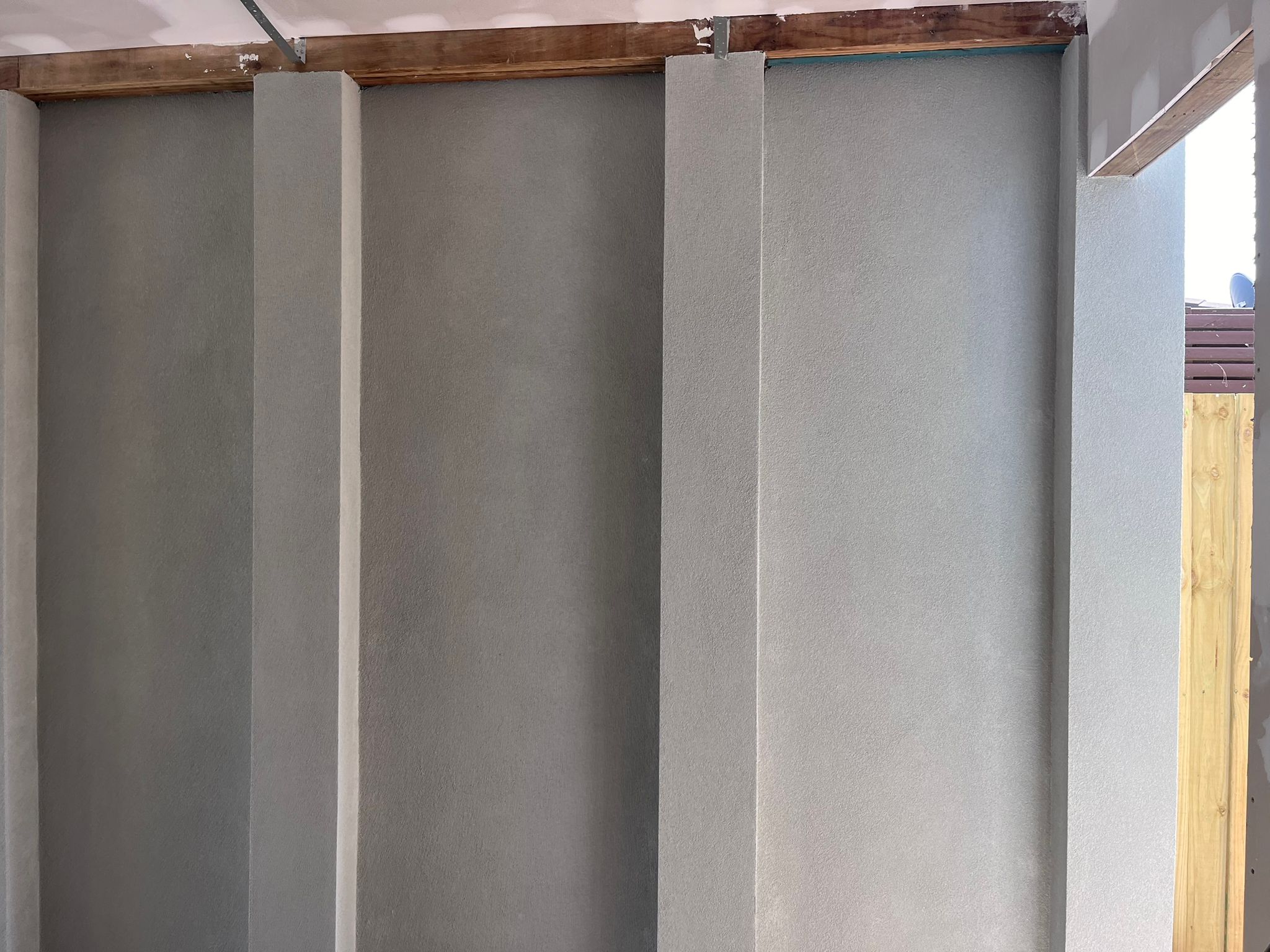 After: Custom Render applied a smooth, clean render to the garage interior walls, creating a polished and professional look. The result is a brighter, more usable space that complements the home’s overall quality and finish.