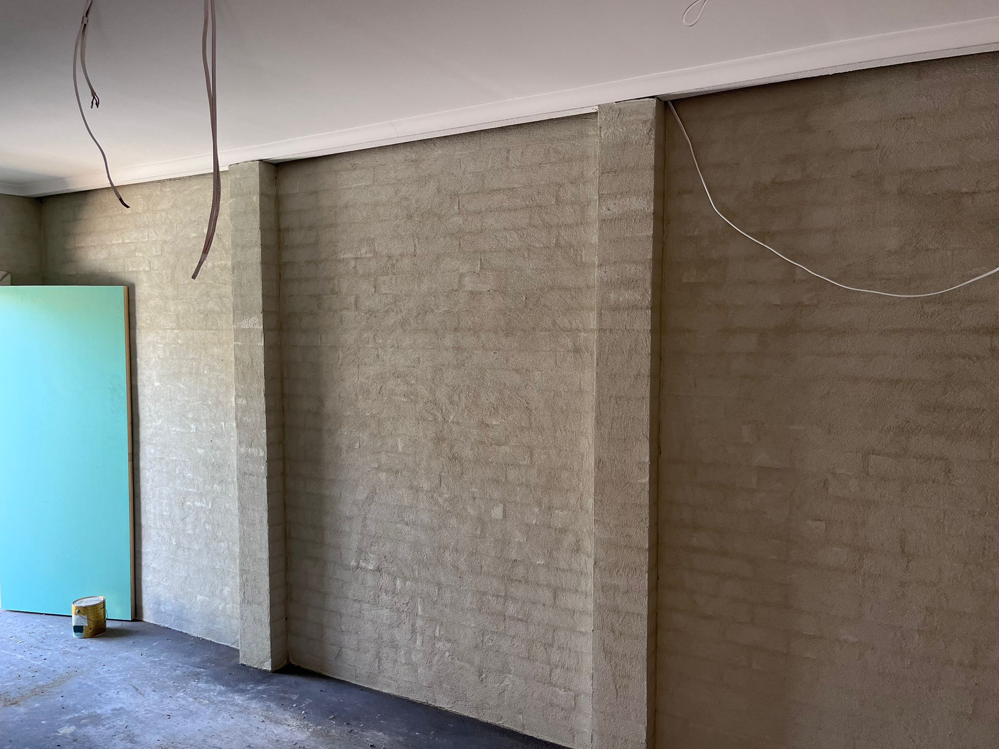 Before: The interior garage walls were bare, rough, and unfinished—giving the space a cold, industrial feel.
