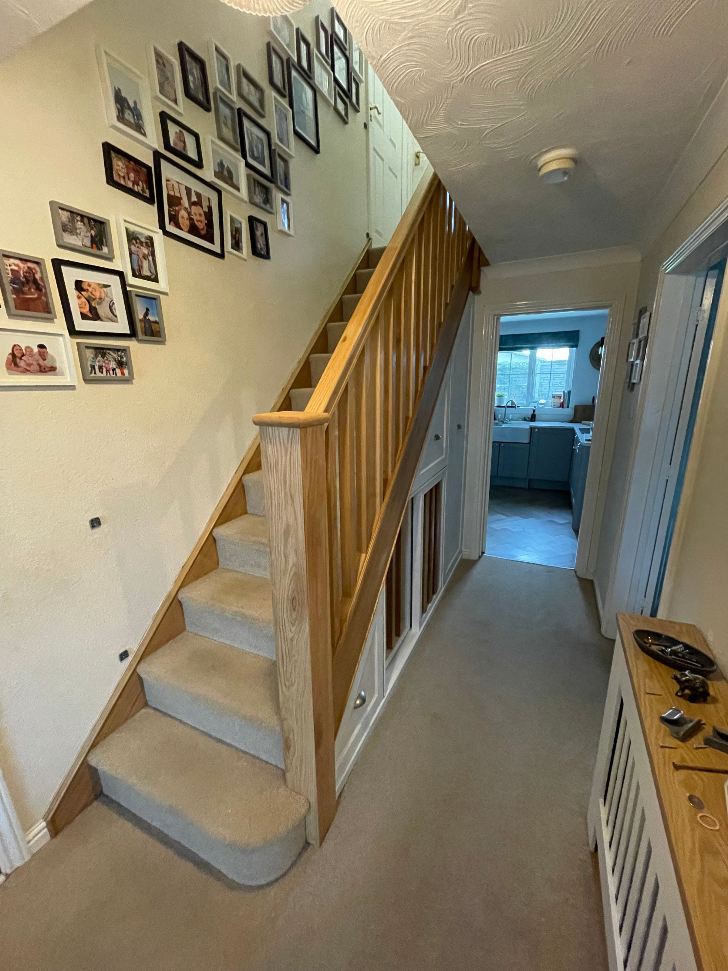 Whole staircase cladded in oak and understair storage completed to a primer finish 