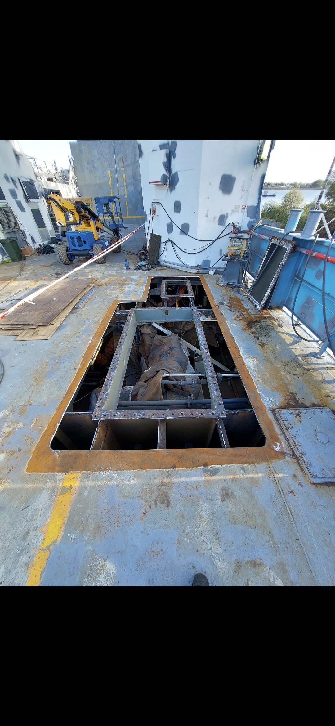 Rusted deck plate cut out on vehicle barge 