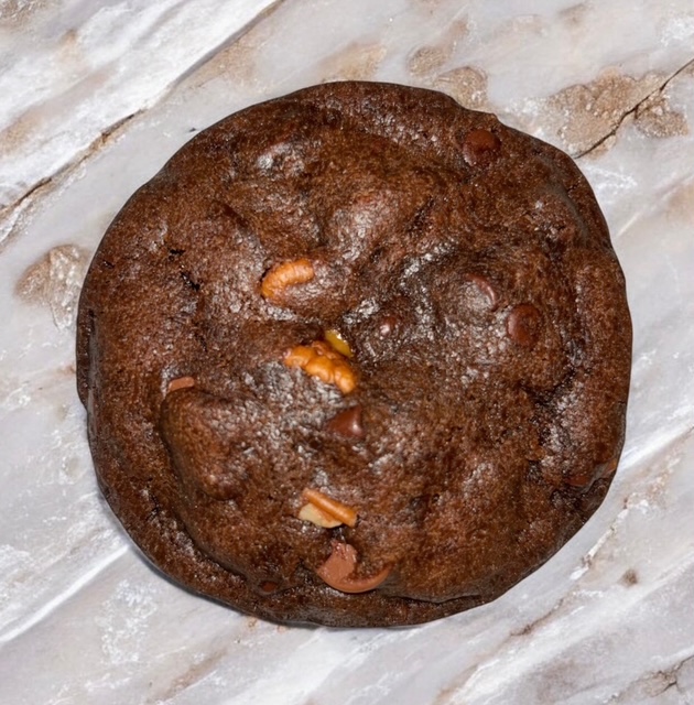 Brownie tasting chocolate cookie with semi-sweet and milk chocolate chips. Loads of Pecans and centered creamy caramel.