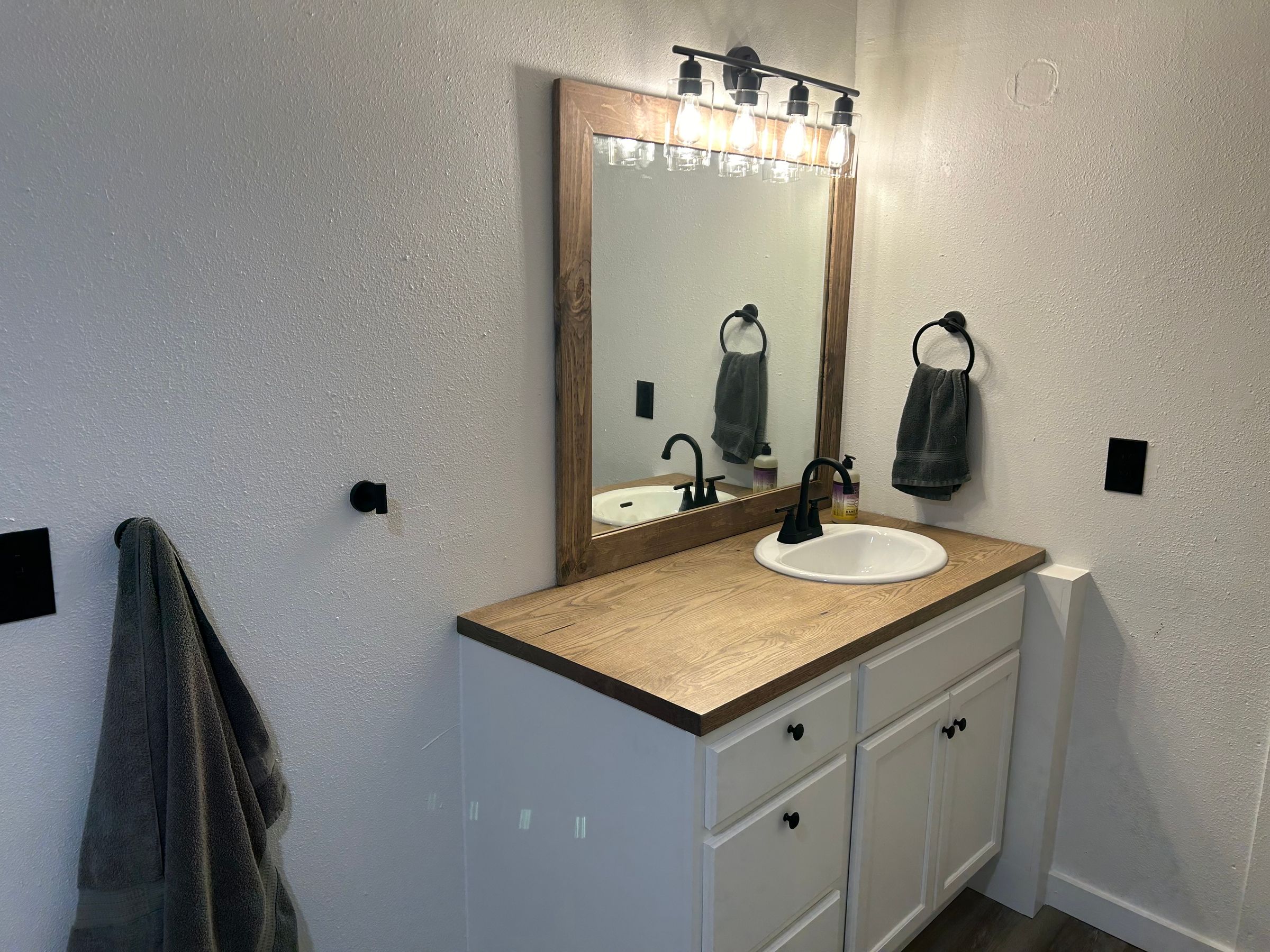 Oak Countertop and Framed Mirror