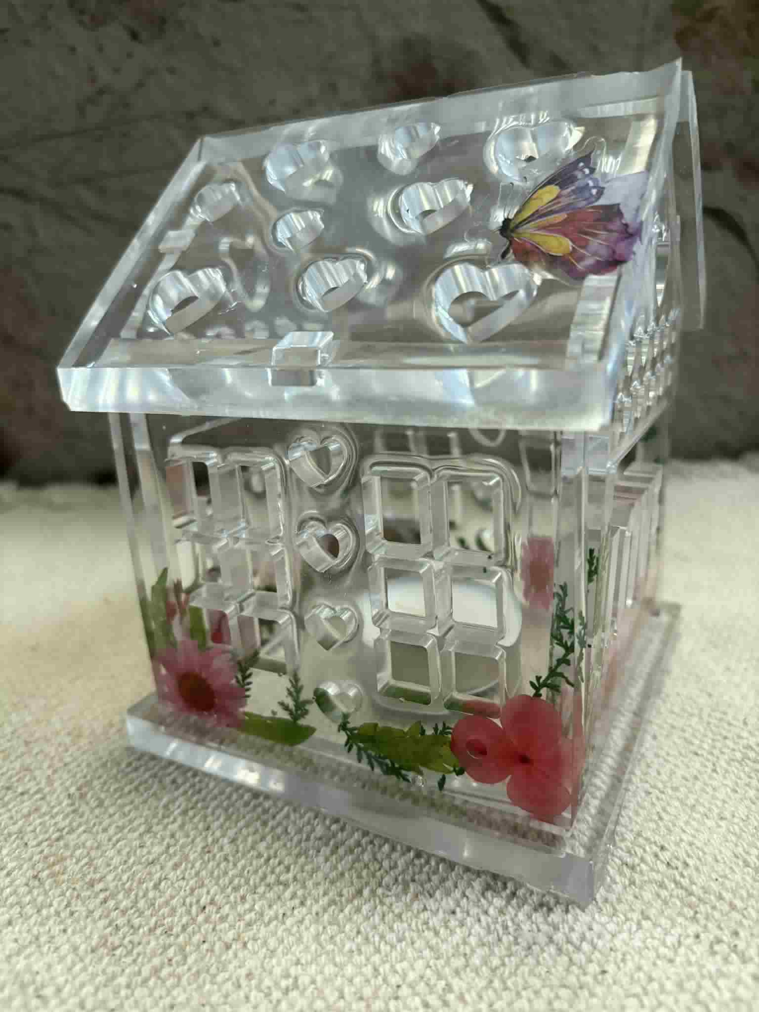This tealight house adds a warm glow and cozy ambiance to any space with its intricate decorative design. Perfect for creating an inviting atmosphere in your home or as a charming gift. Customizable! $24.00