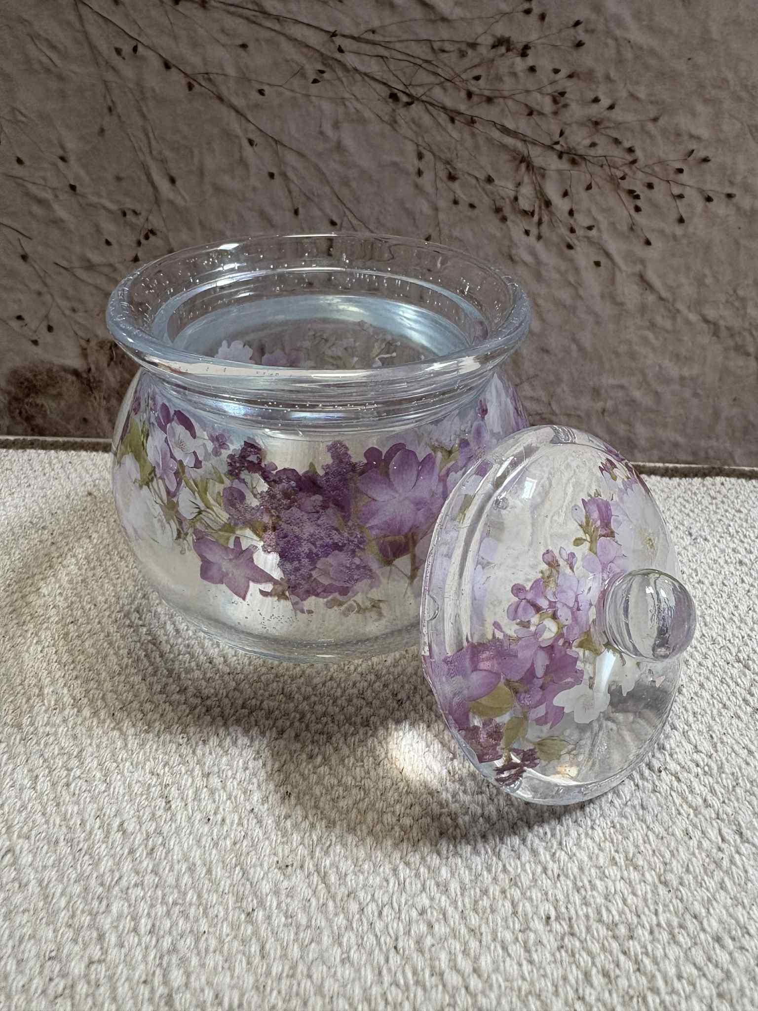 This trinket jar with lid features a stylish design and secure storage, making it perfect for organizing small items while adding a touch of charm to any space. Available in a variety of colors and designs for $15.00.