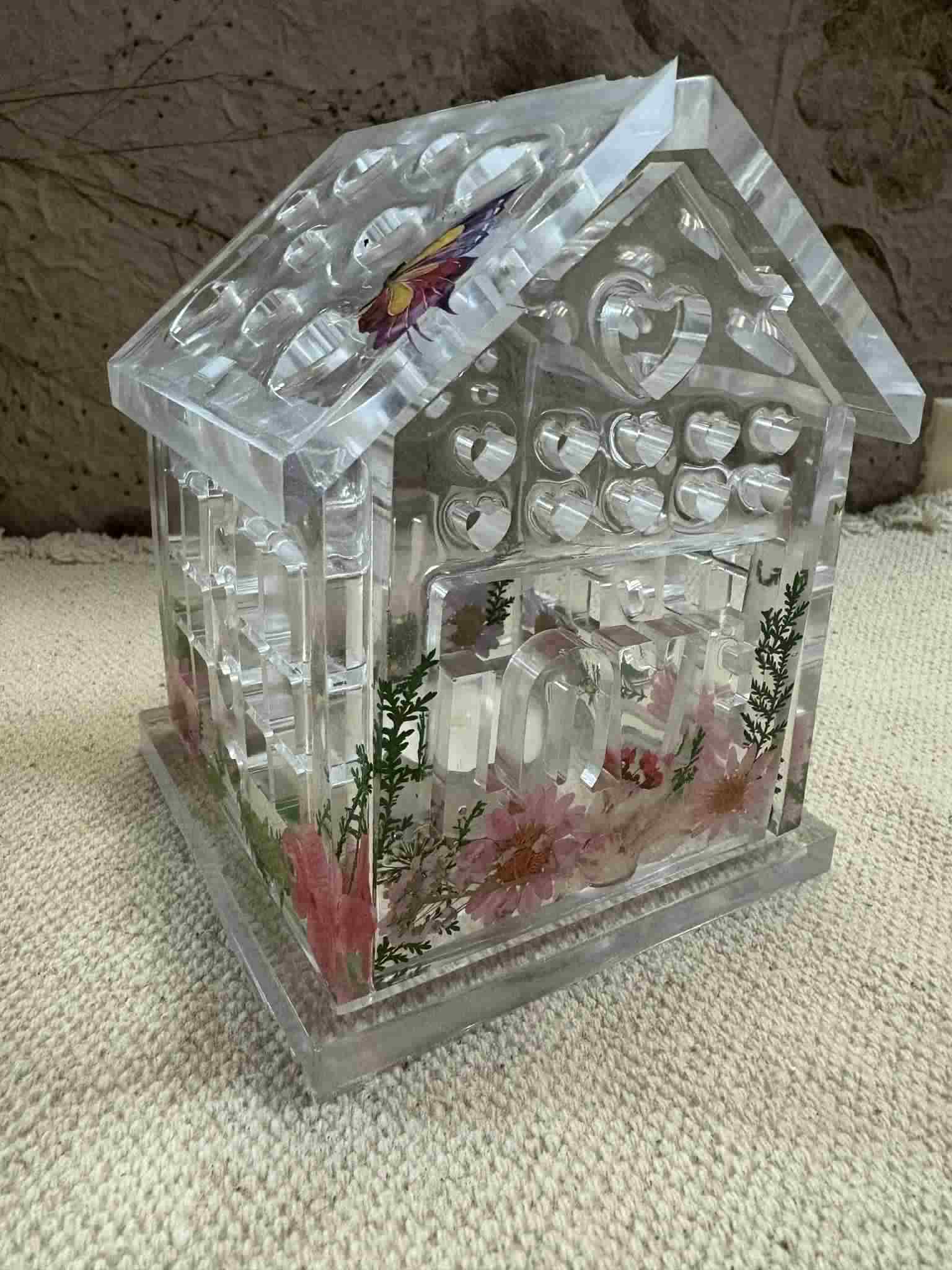This tealight house adds a warm glow and cozy ambiance to any space with its intricate decorative design. Perfect for creating an inviting atmosphere in your home or as a charming gift. Customizable! $24.00