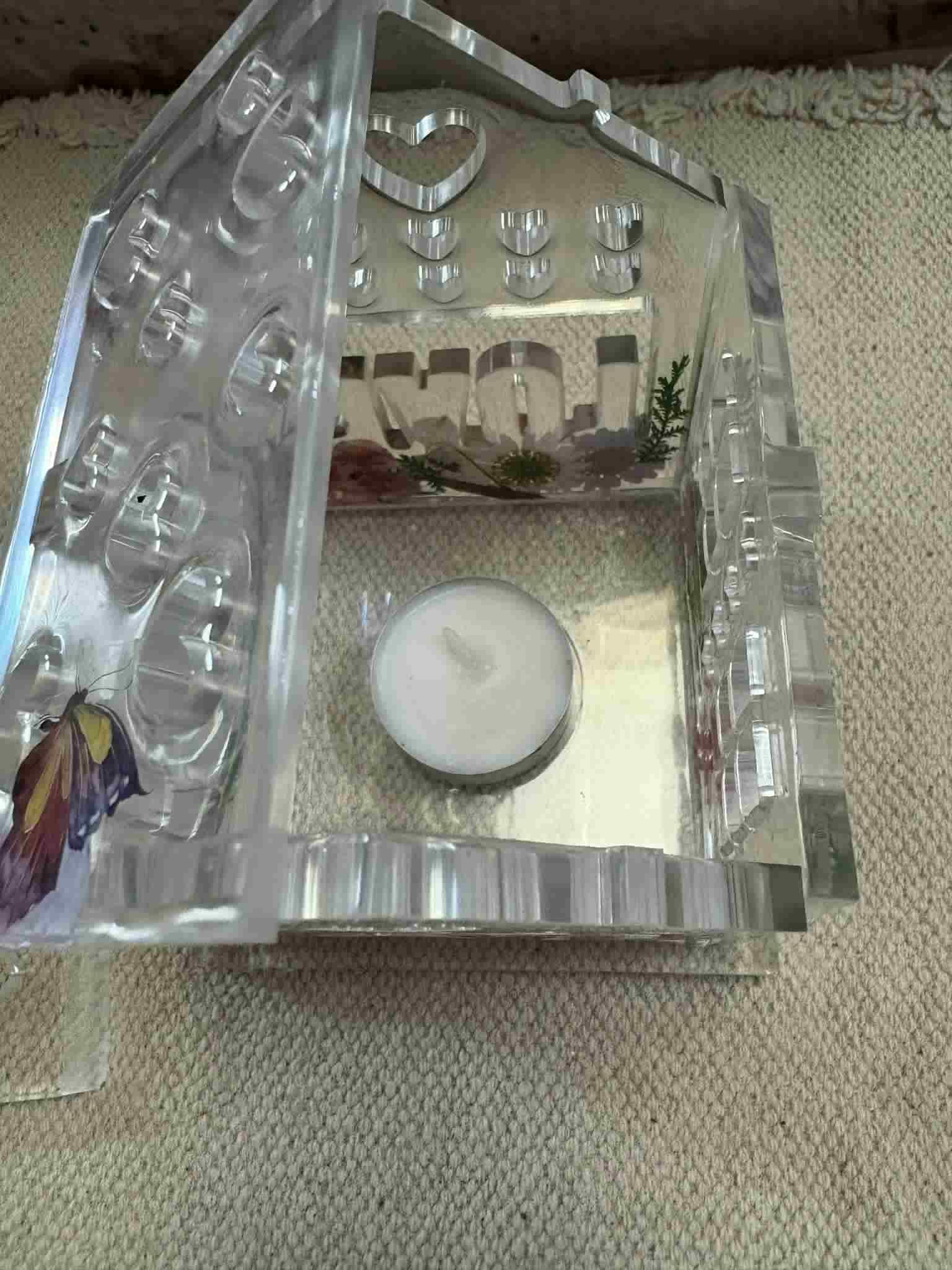 This tealight house adds a warm glow and cozy ambiance to any space with its intricate decorative design. Perfect for creating an inviting atmosphere in your home or as a charming gift. Customizable! $24.00