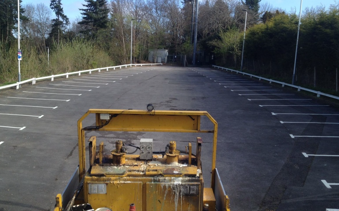 Refreshing parking bays for a railway carpark.