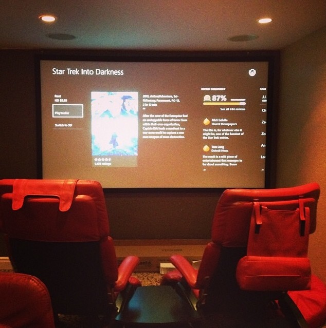 Home theater projector screen installation with clean wall mounting setup in Miami-Dade County