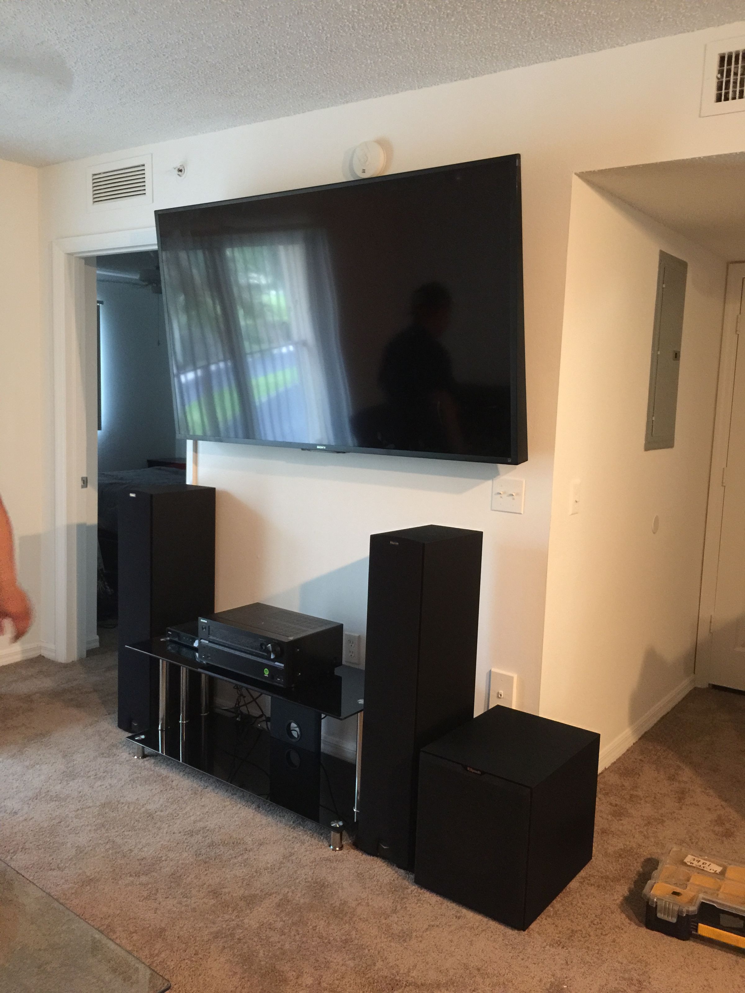 Smart TV wall-mounted with full surround sound setup, speakers, and receiver installation in Homestead, Florida.
