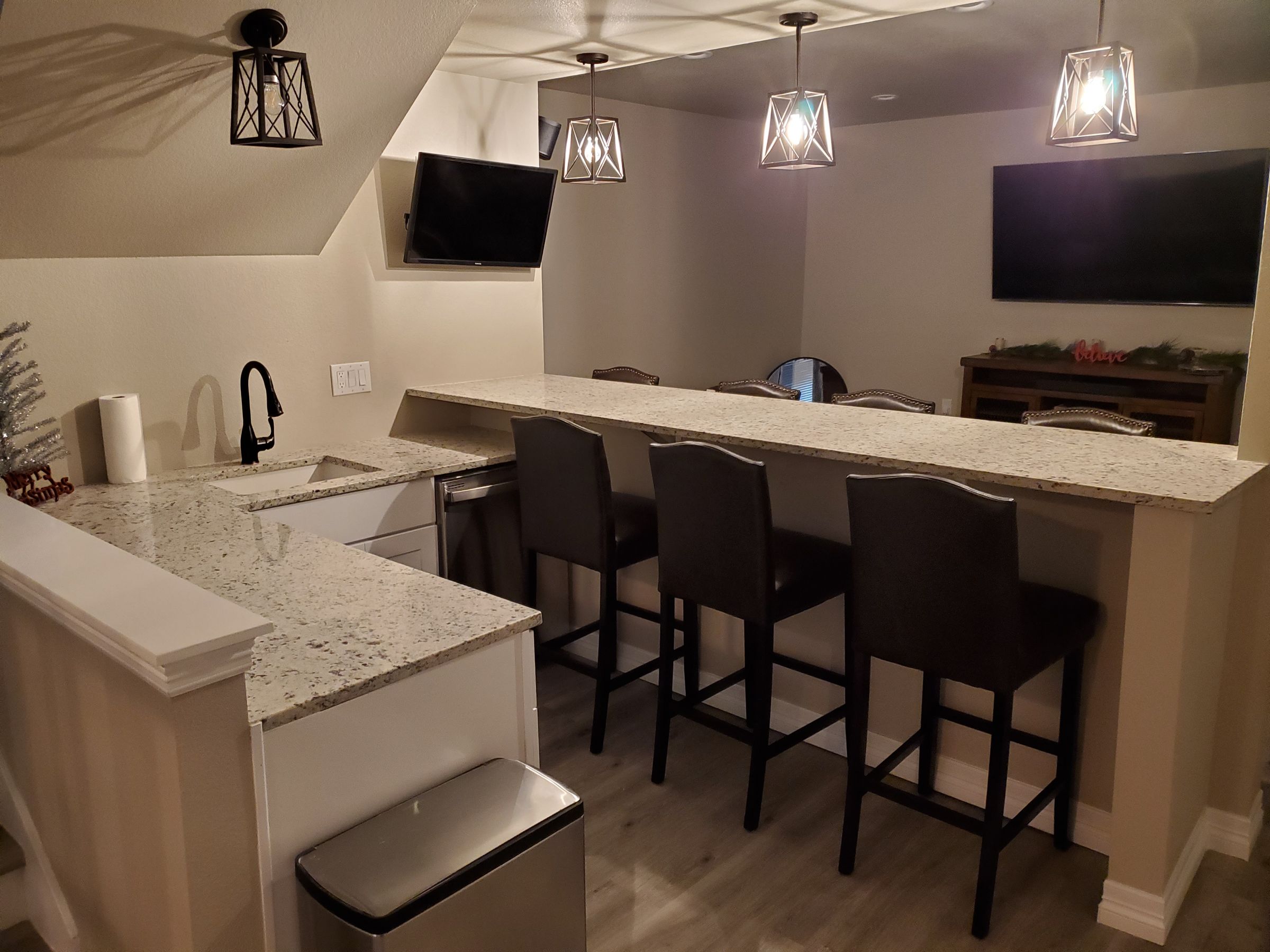 We removed the unfinished area under stairs and added space to basement by putting the bar under the stairs