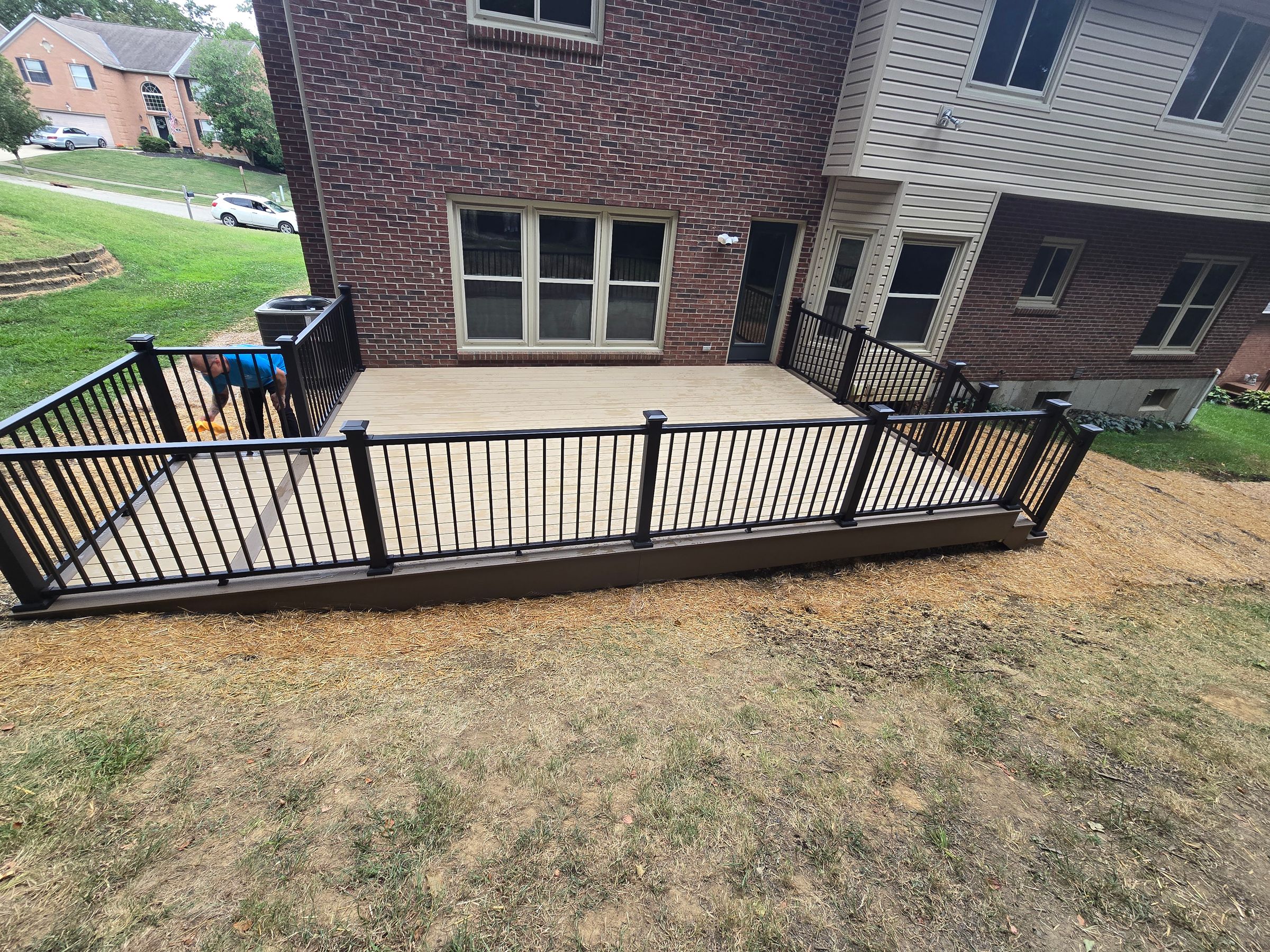 Composite deck w/ black aluminum rails w/ post and step lighting