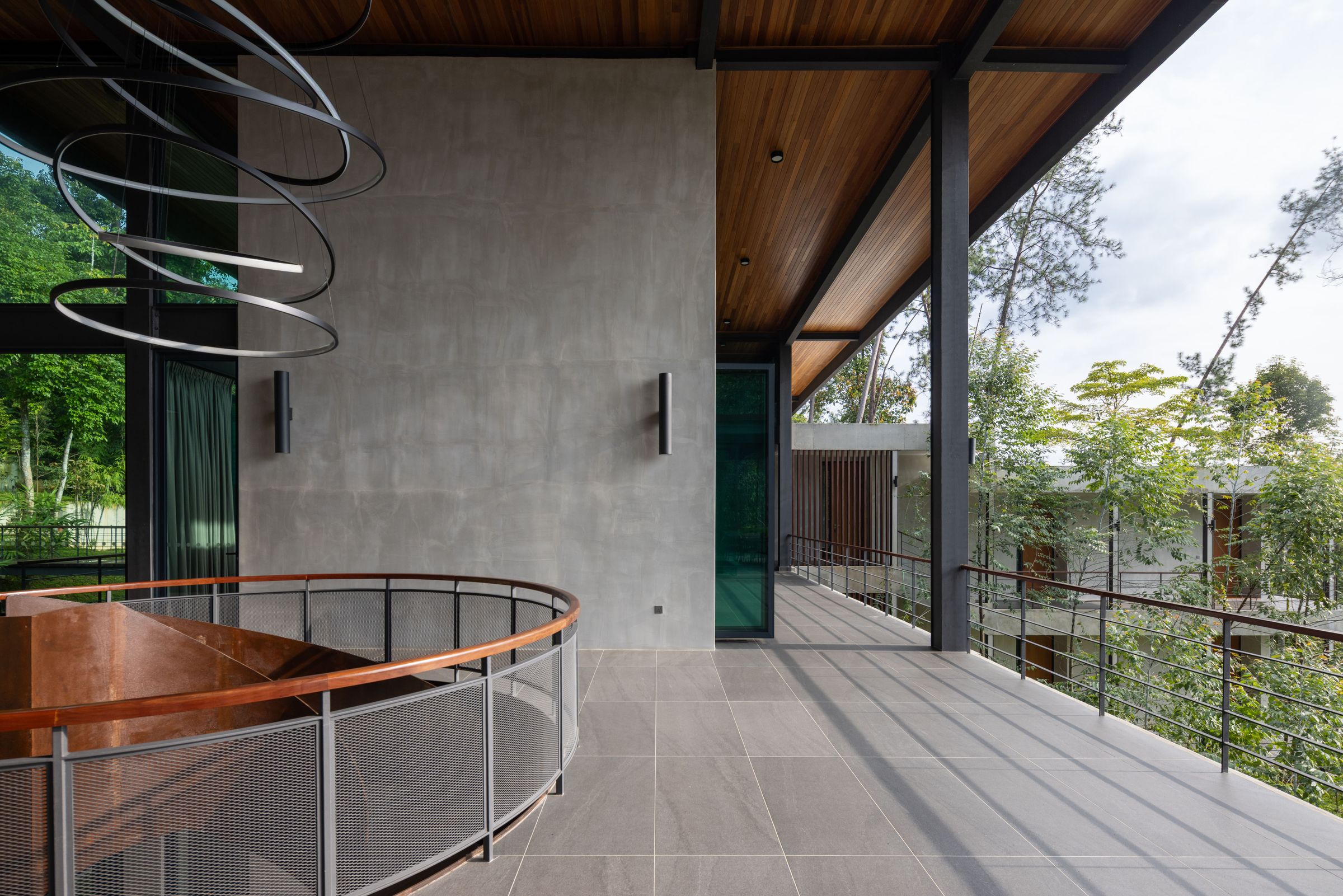 Timber walkway at SereneNest with a sculptural spiral light fixture overhead