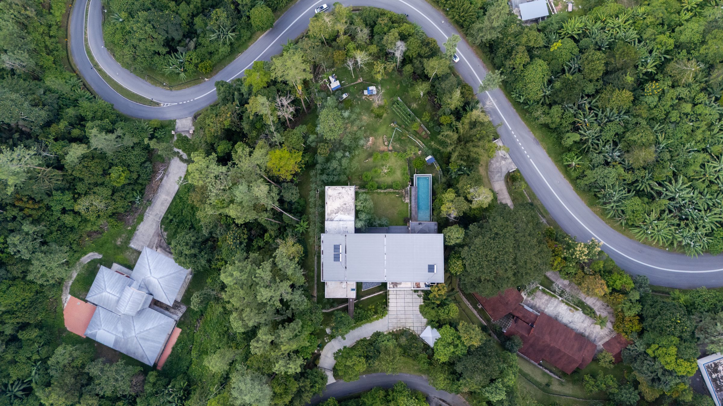 Aerial drone view of SereneNest retreat villa nestled in the Janda Baik rainforest