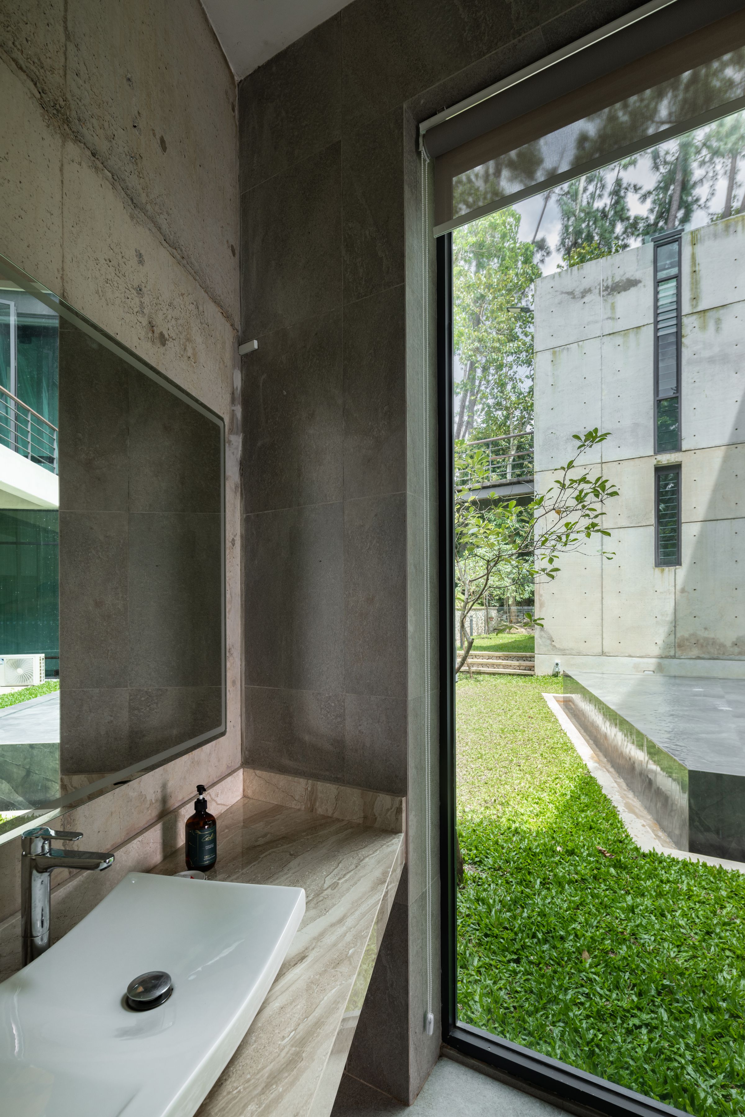 Bathroom at SereneNest with a freestanding tub and a large window onto the garden