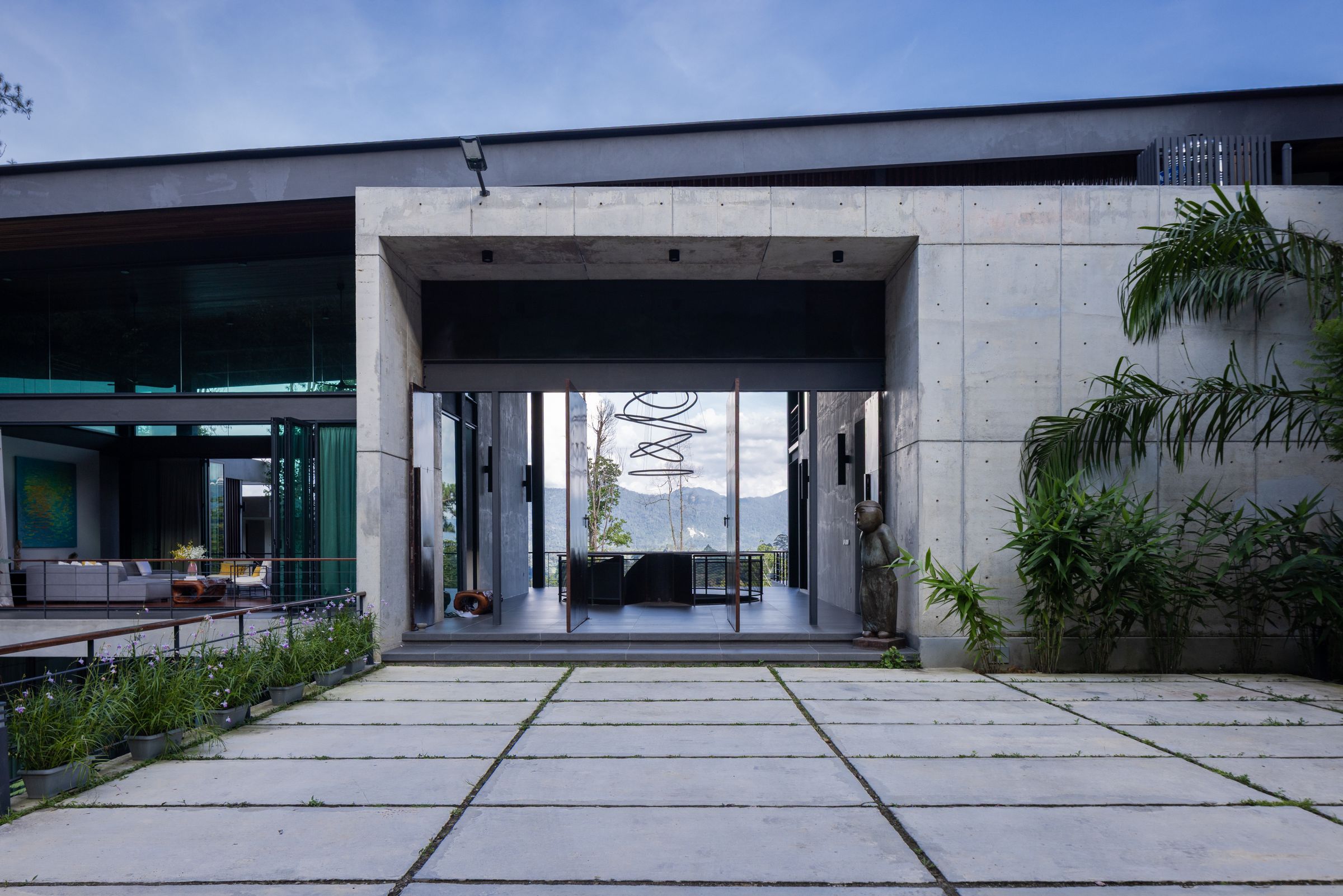 Wide concrete paver courtyard between the SereneNest villa pavilions