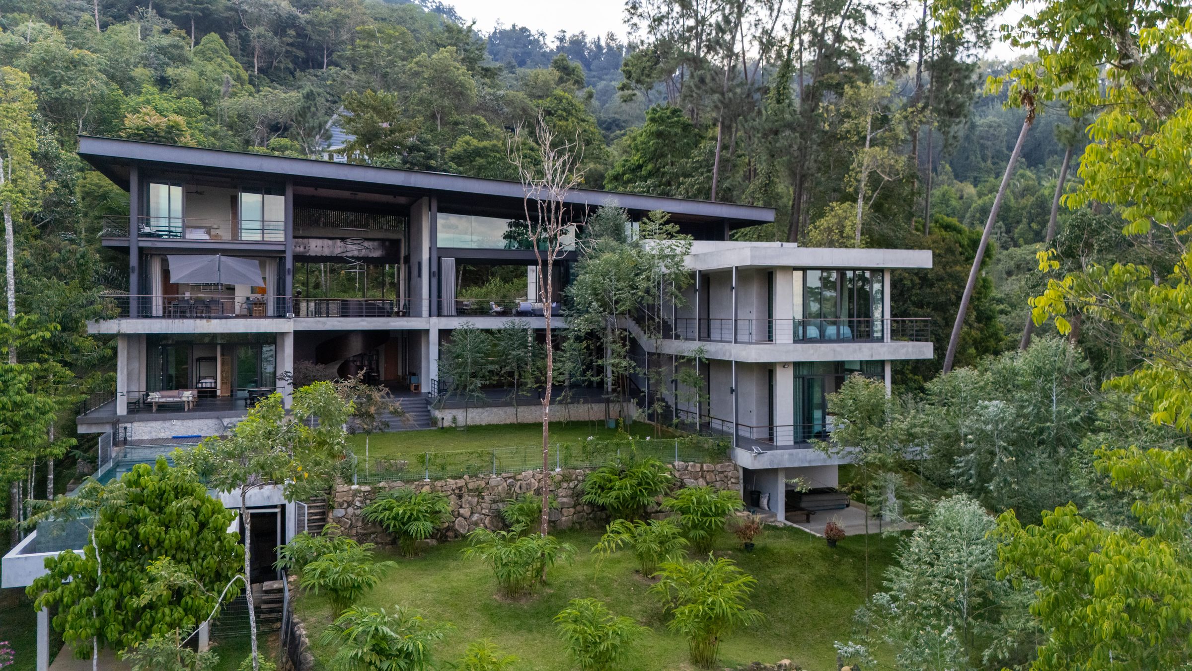 Distant view of the SereneNest villa nestled into a hillside of Janda Baik rainforest