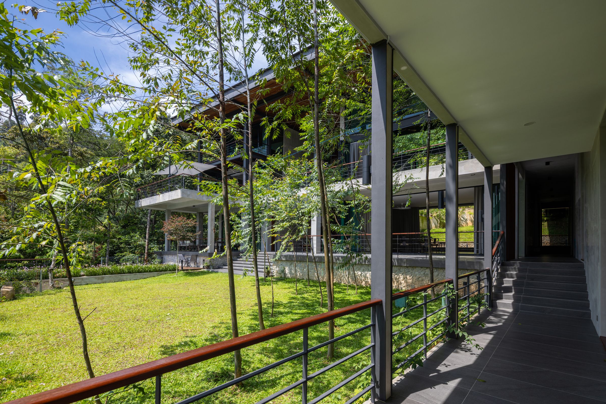 Retreat villa bedroom opening to the rainforest canopy at SereneNest, Janda Baik