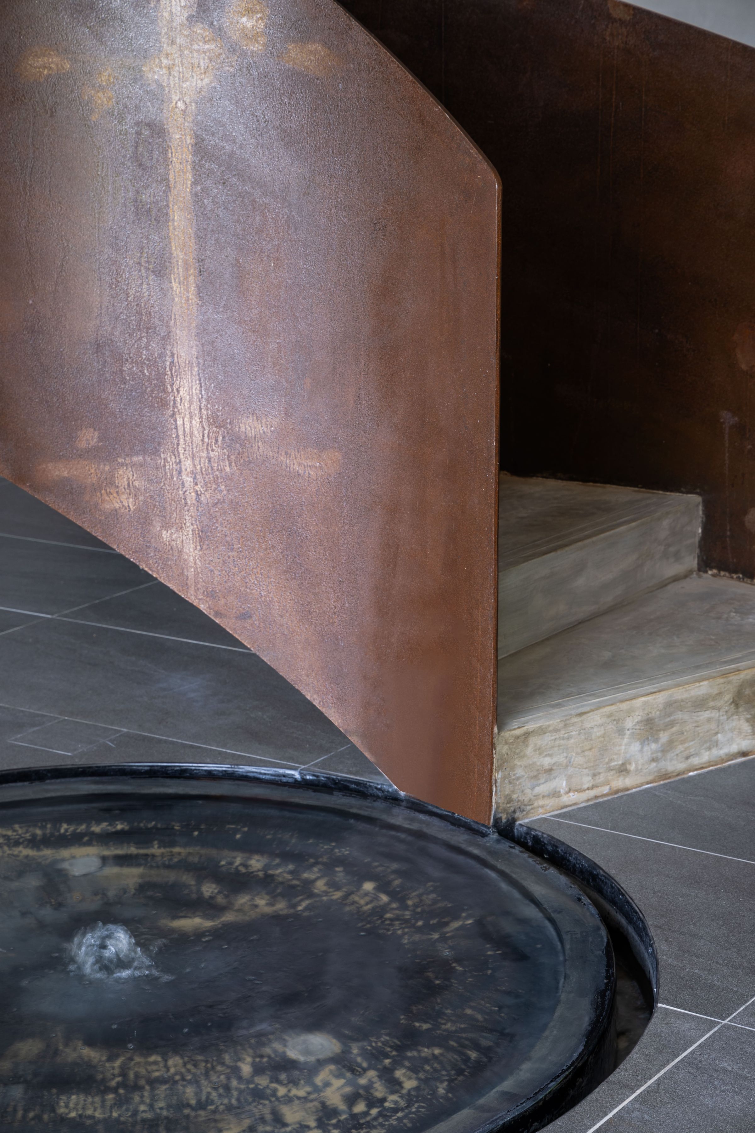 Architectural detail of the SereneNest spiral staircase base in timber and concrete