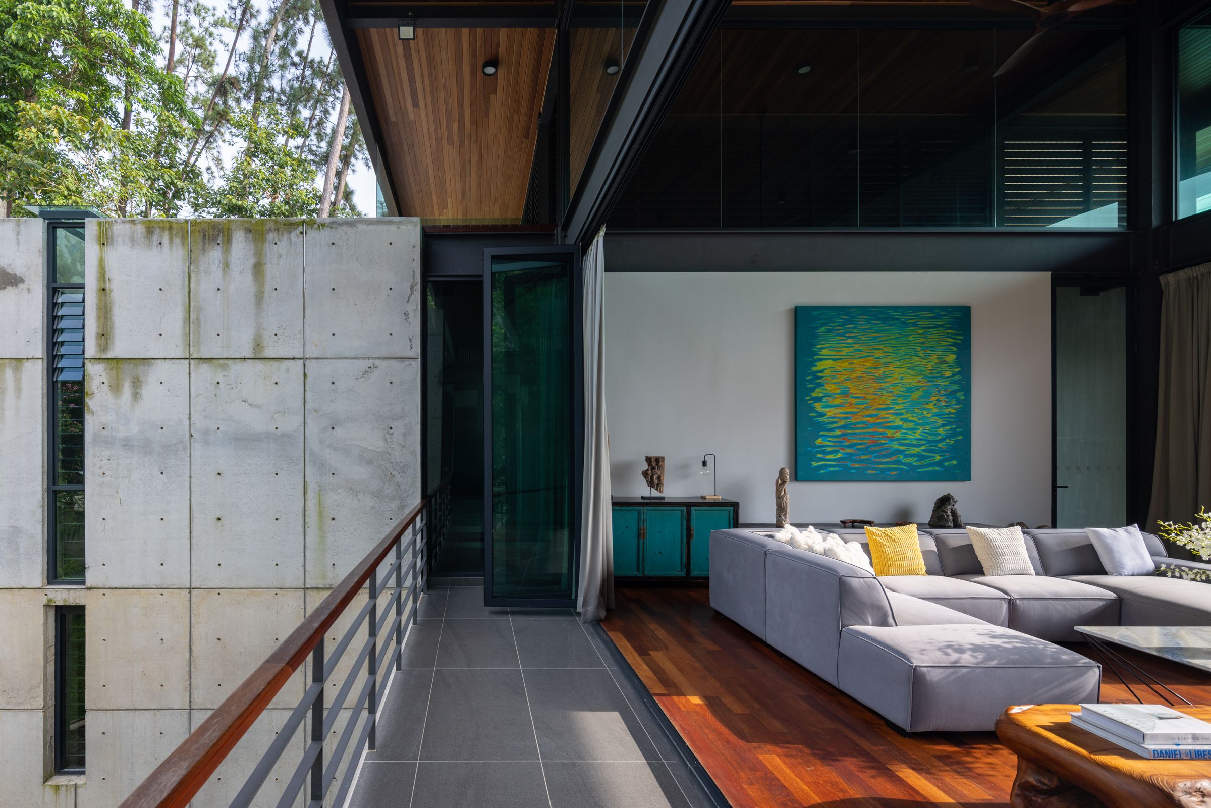 Open lounge and dining at SereneNest with sofa, art and a view to the Bukit Tinggi hills