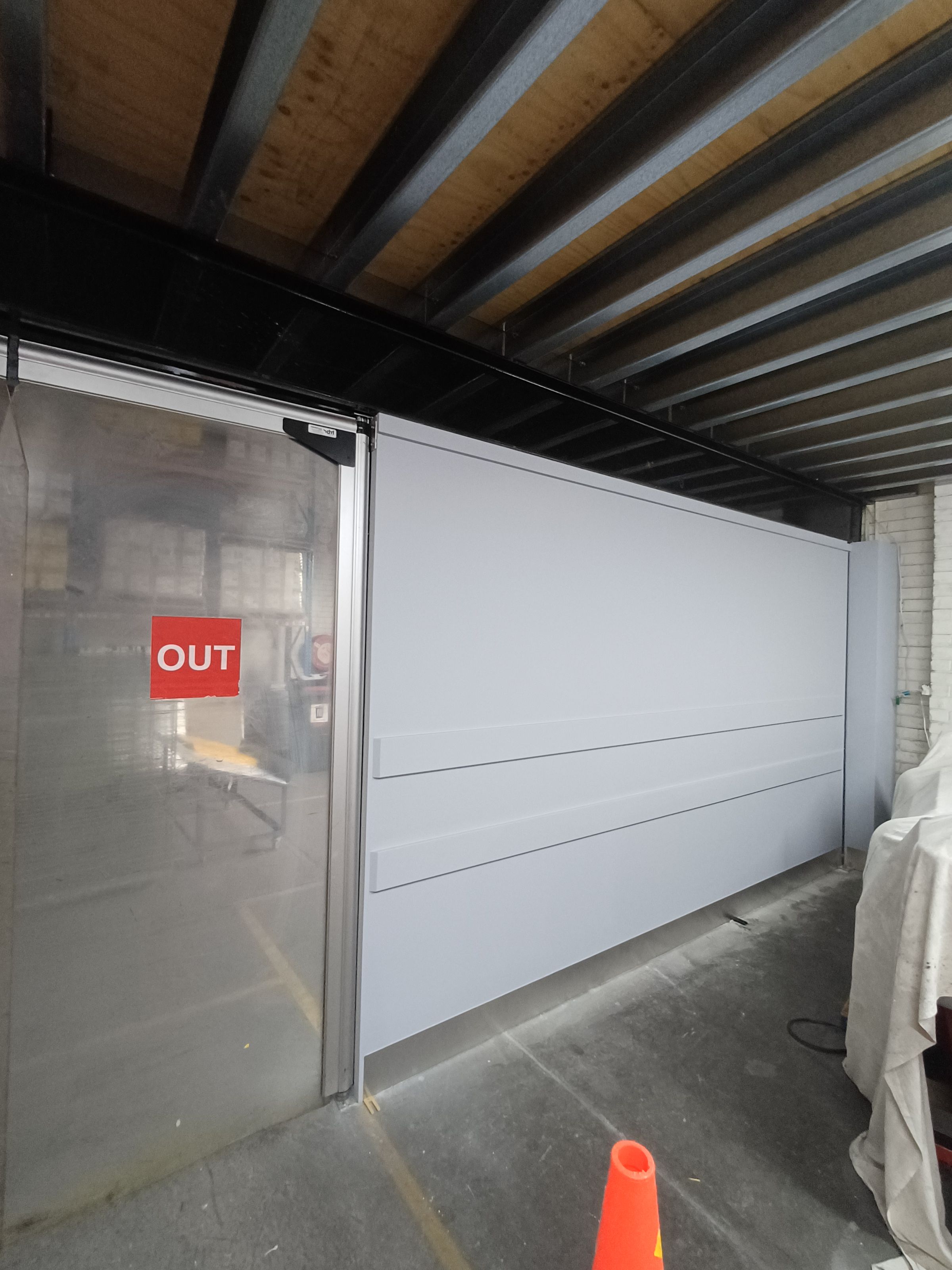 New wall with Timber rails for items to lean on.