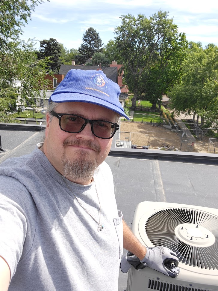 Tech on Roof Servicing AC