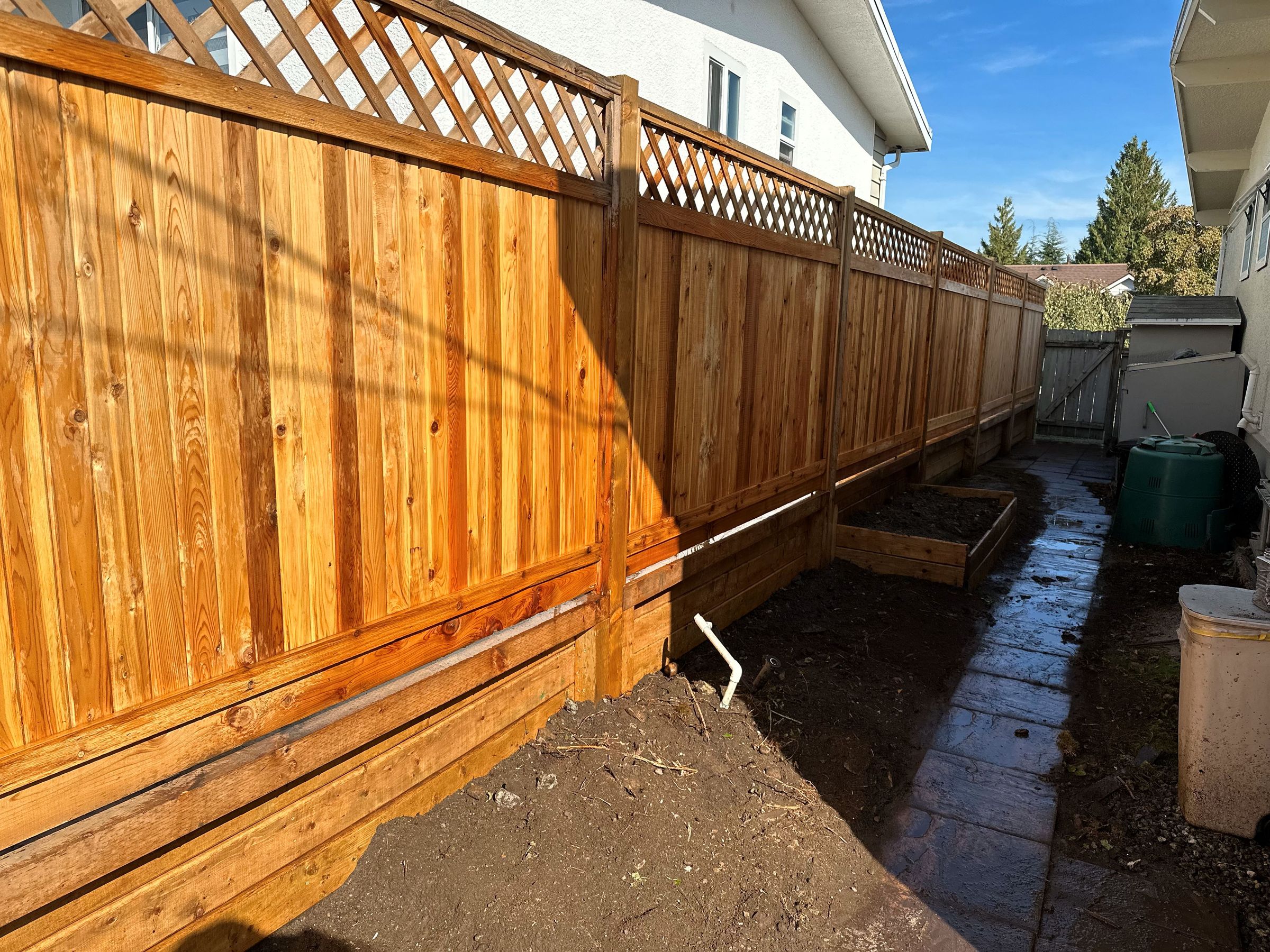 We removed the retaining wall, and completely re-did the area of the fence as the clients requested area 