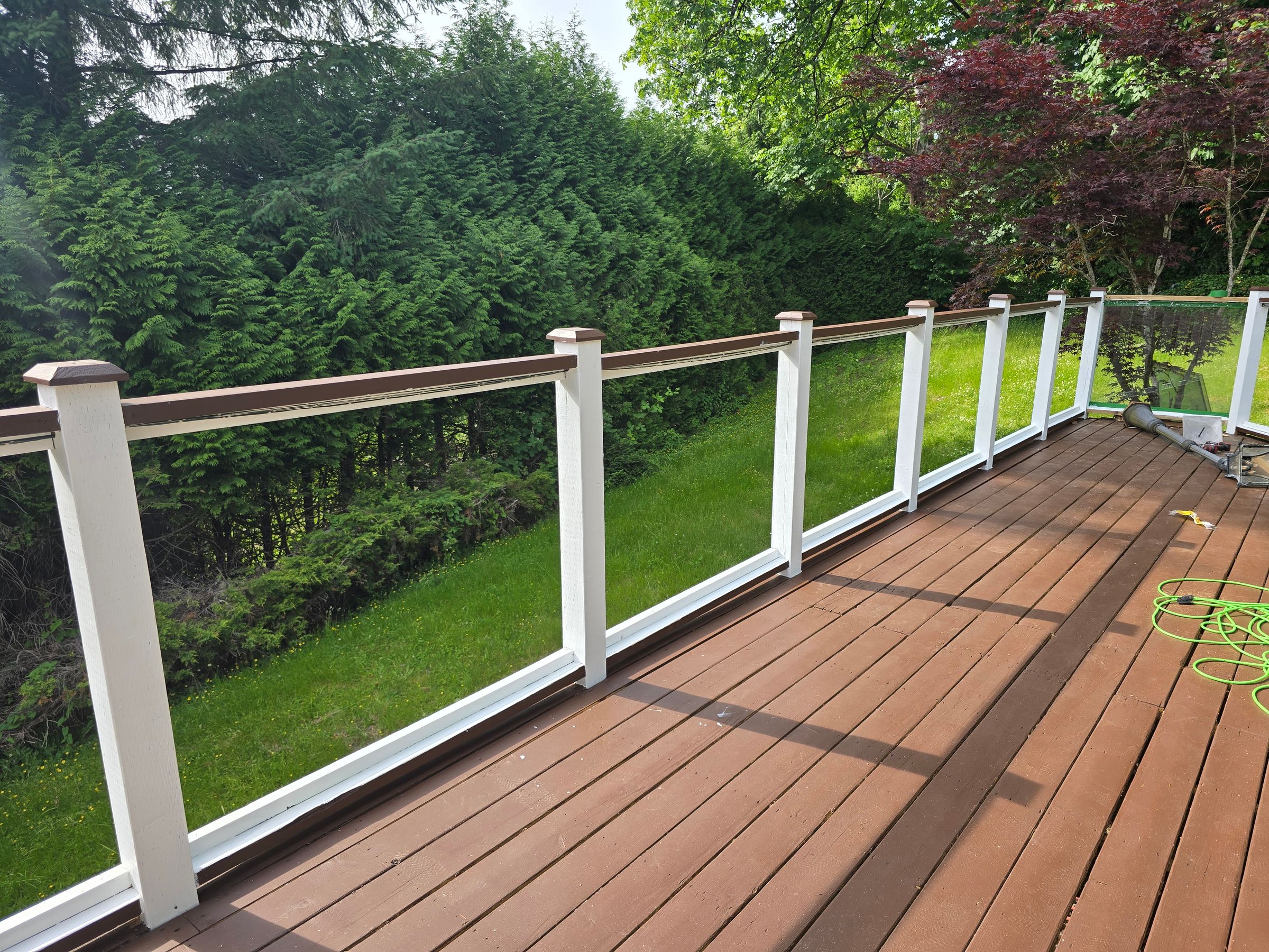 Refurbished deck with a custom built railing for glass inserts